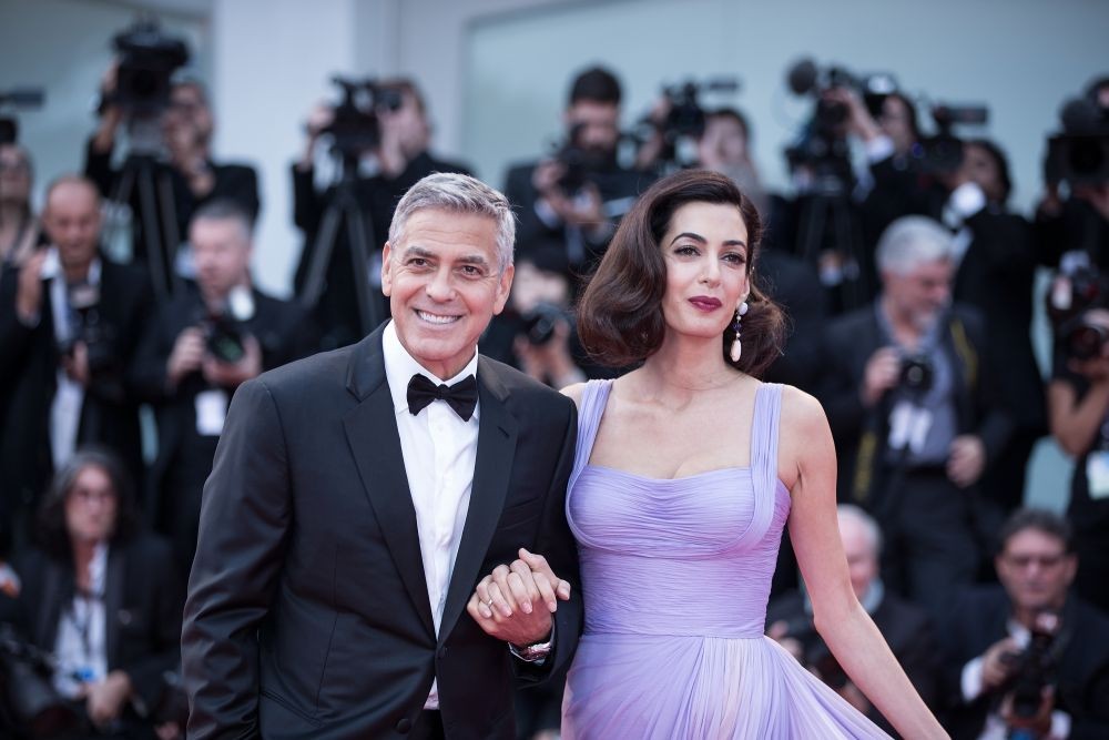 VENICE, Sept. 3, 2017 (Xinhua) -- Director George Clooney (L) and his wife Amal attend the premiere of the movie "Suburbicon" in competition at the 74th Venice Film Festival in Venice, Italy, Sept. 2, 2017. (Xinhua/Jin Yu/IANS)